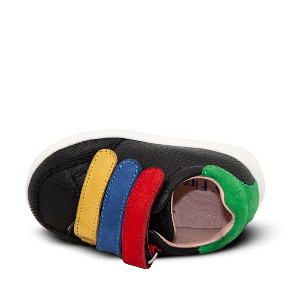 A child's black sneaker with multicolored straps
