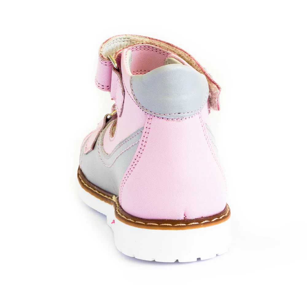 a child's pink boot with a white sole