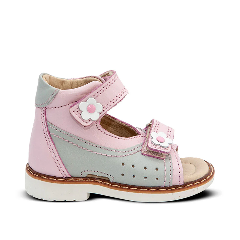 a child's pink and grey shoe with a flower on the side