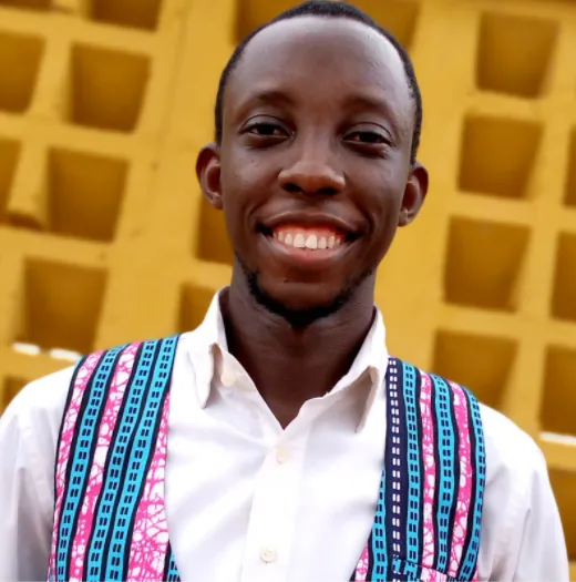 a man in a white shirt and blue and pink suspenders