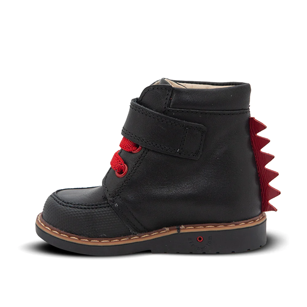 A child's black boot with red spikes on the back