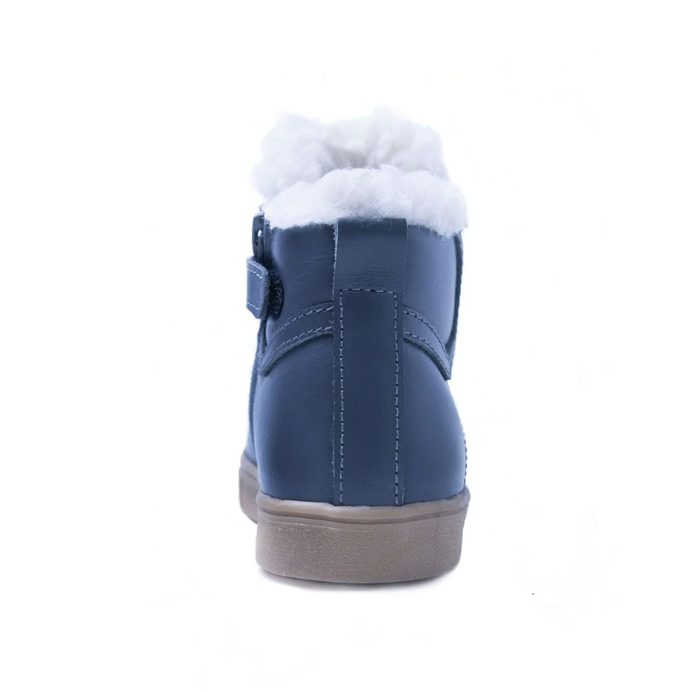 a child's blue boot with white fur
