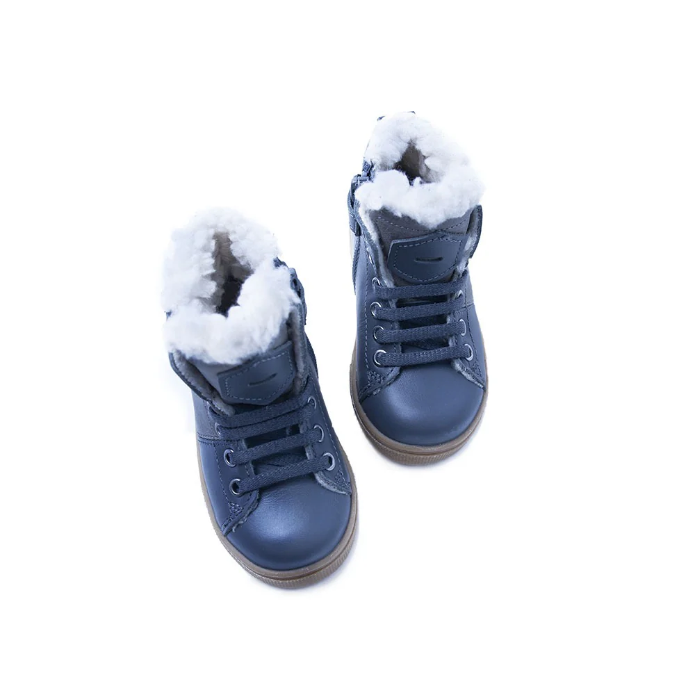 a pair of blue shoes with a fur lined top