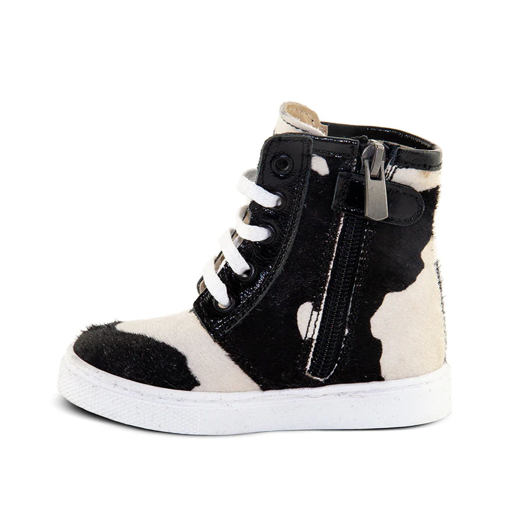 a black and white high top sneaker with zippers