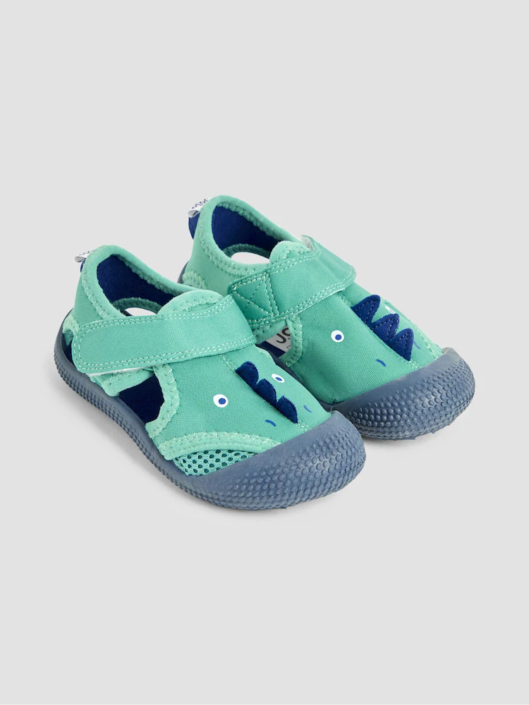 a pair of green shoes with blue straps.