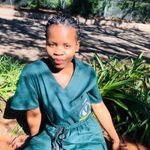 a woman in scrubs sitting on the ground