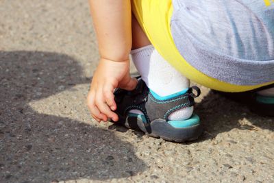 a small child wearing a pair of  no lace shoes