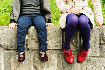 A boy and a girl wearing comfy kids' shoes.