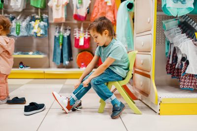 A little boy trying on Clarks kids shoes alternatives.