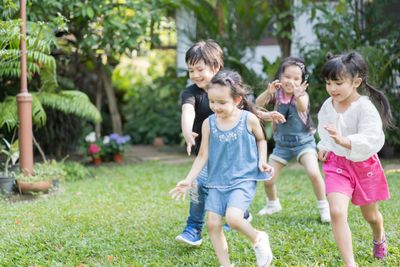 A group of children wearing well-fitted shoes while playing outside to prevent plantar warts.