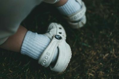 A close up of a toddler's feet while they're wearing Crocs.