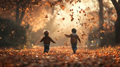 two young boys are playing in the leaves