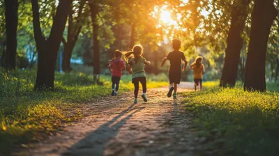 a group of children running down a dirt road