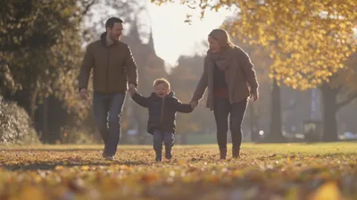 a man, woman and child walking through a park