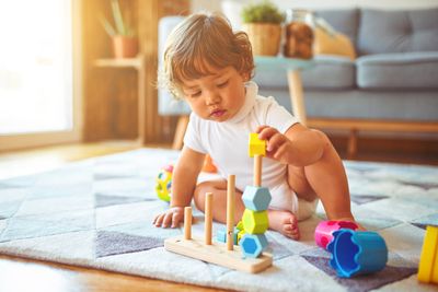 Gift ideas for kids: a toddler playing with toys.