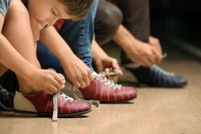 High tops vs. low tops: kids tying their shoes.