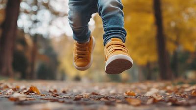 a person is running through the leaves in a park