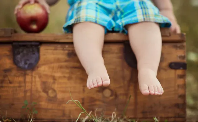 a child sitting on top of a wooden box
