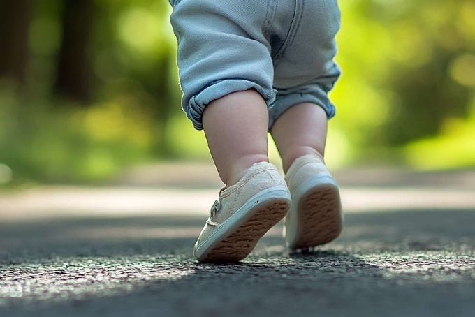 A baby doing a heel raise exercise.