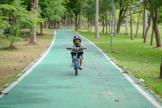 A little boy riding a balance bike, a gift idea for an active kid.