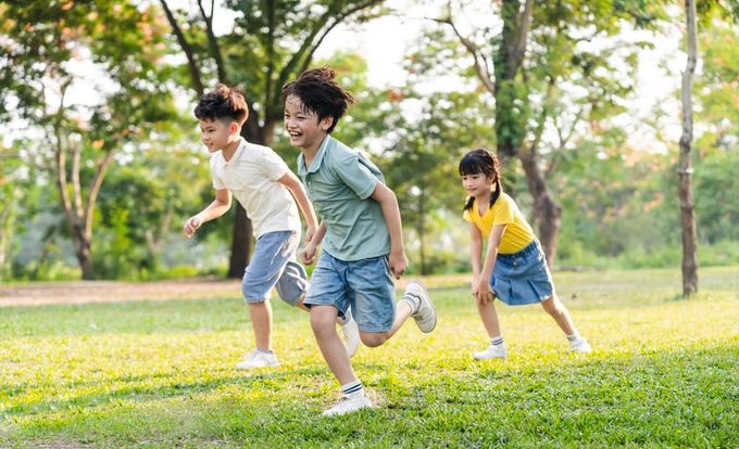 A group of young children playing a game of soccer.