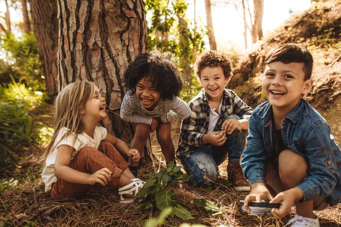 A group of young children wearing the best shoe brands for kids.