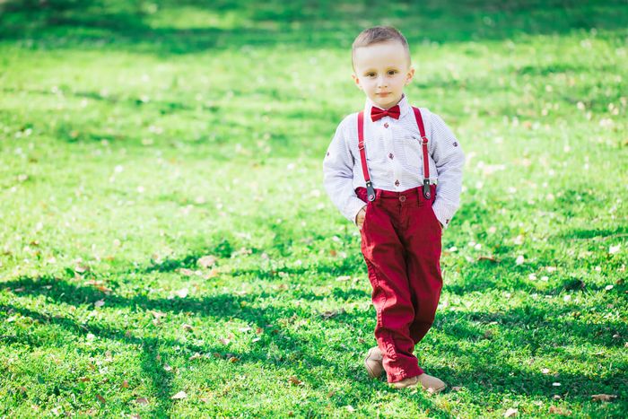 A dapper little gent wearing formal toddler boy shoes.