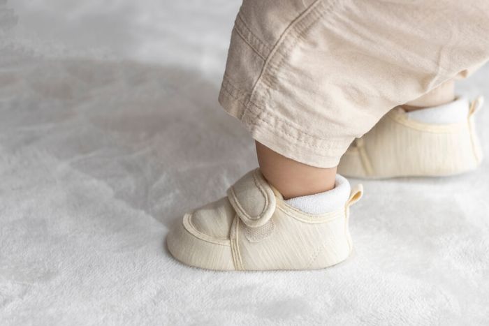 A baby wearing shoes.