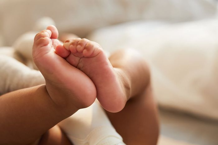 A close up of a baby's red feet.
