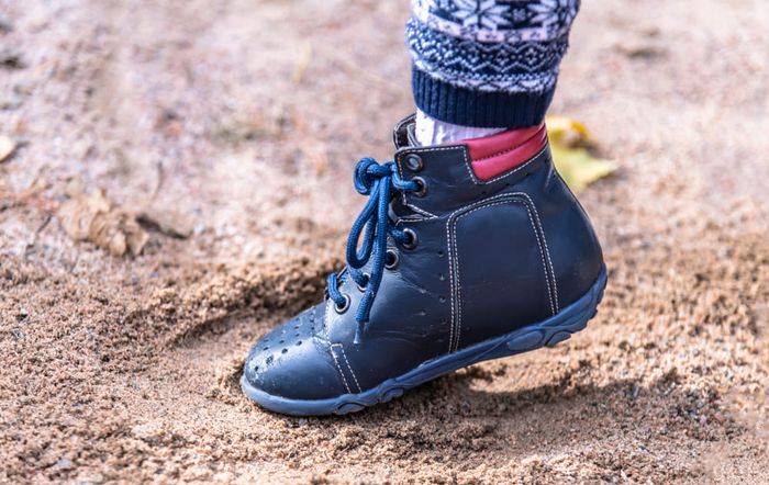 a close up of a person's feet wearing blue shoes