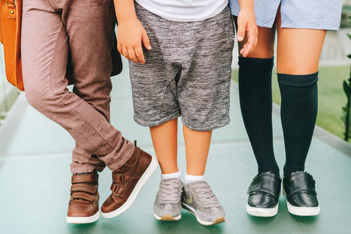 A group of kids wearing shoes with proper arch support.