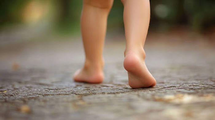 A close up of a child's legs and feet.