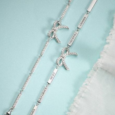 a couple of silver bracelets sitting on top of a table