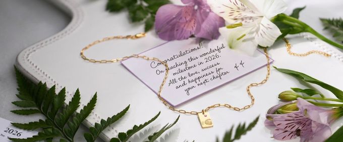 gold graduation jewelry with a note for a graduate