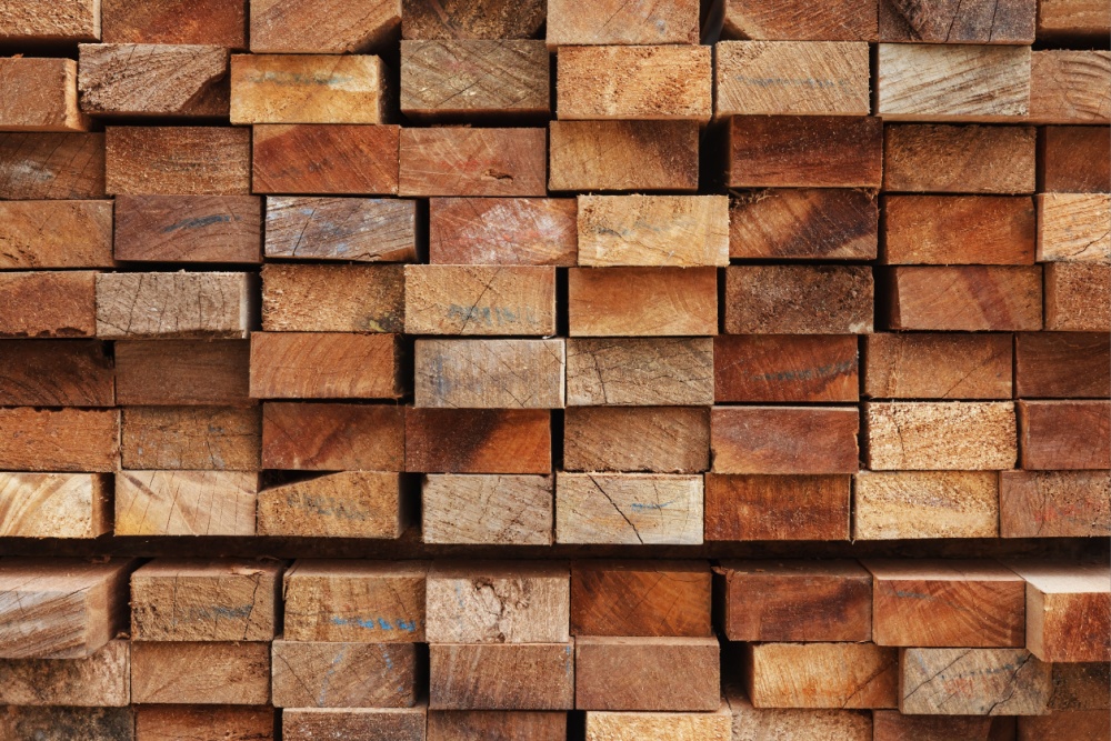 timber-sawmill A pile of wooden planks on top of each other in a sawmill