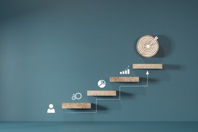 Wooden stairs with graphs symbolizing research, data trends, and targets