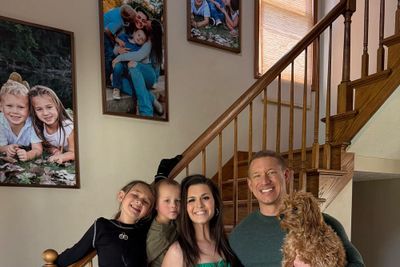 A family standing next to a stairwell.