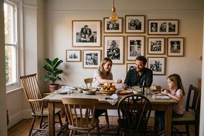 solid-wood frames of candid family photos above a lived-in family dining table.