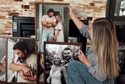 A woman deciding how to decorate her living room wall.