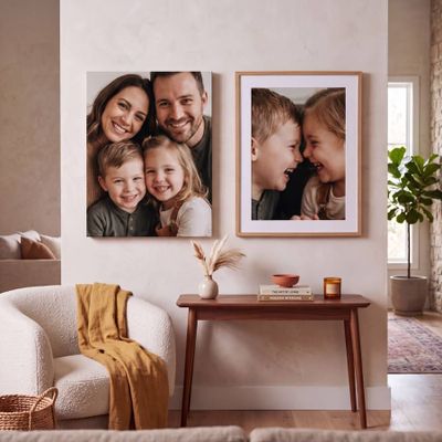 a couple of pictures hanging on a wall next to a table