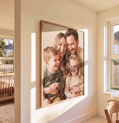 a family picture hanging on a wall next to a window