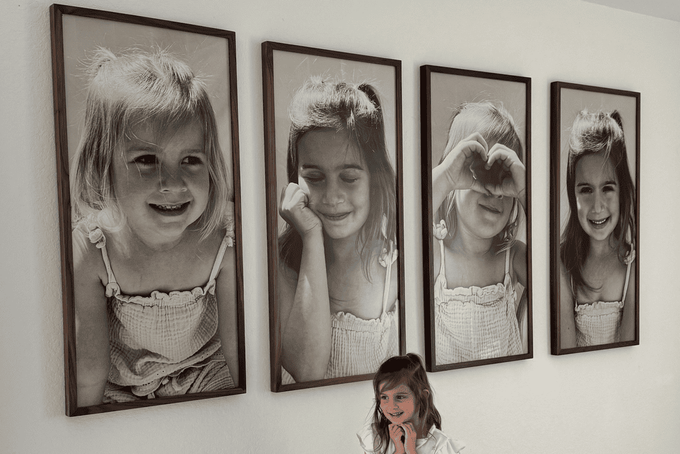 11 Gallery Wall Layout Ideas for a Flawless Display A girl standing under a gallery wall layout.
