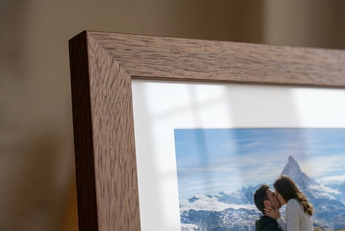Example of a FrameForest Silk Print Close-up of a solid-wood frame corner with a white mat and a clear acrylic overlay showing a faint reflection of window light.