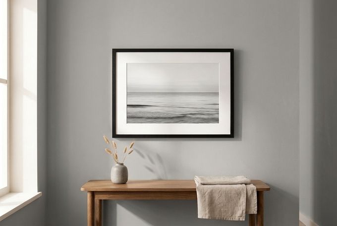 a picture hanging on a wall above a table