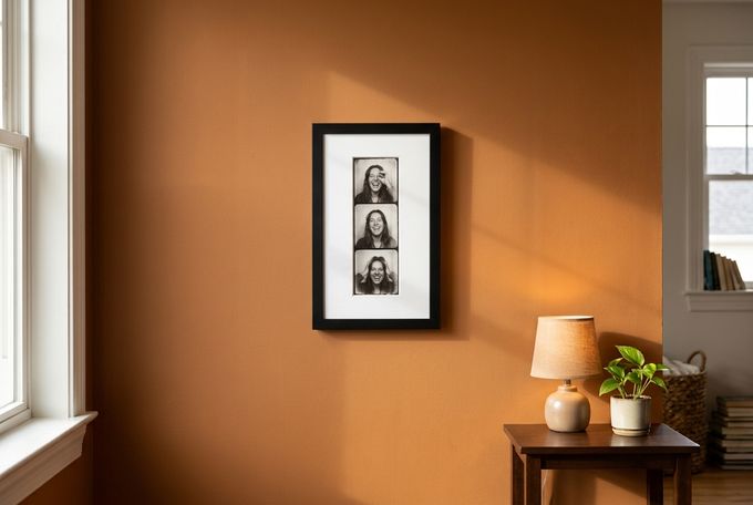 a picture hanging on a wall next to a lamp