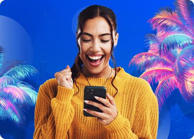 a woman laughing while looking at her cell phone