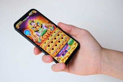 a person holding a cell phone in their hand