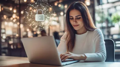 a woman sitting at a table using a laptop