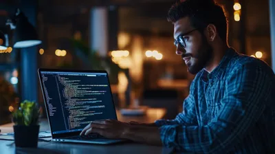 a man sitting in front of a laptop