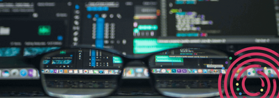 a pair of glasses sitting on top of a laptop computer